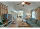 Open living room featuring vaulted ceiling, ceiling fan, and access to the kitchen at 271 Raintree Dr, Casselberry, FL 32707