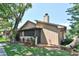 A screened-in porch provides a shady outdoor retreat adjacent to lush landscaping and mature trees at 271 Raintree Dr, Casselberry, FL 32707