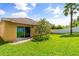 Well-maintained backyard with lush green grass and sliding glass doors to the house at 2733 Big Timber Dr, Kissimmee, FL 34758