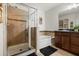Bathroom features a glass enclosed shower and a tub with tile surround at 2733 Big Timber Dr, Kissimmee, FL 34758