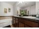 Bathroom featuring double sinks with dark countertops and a separate bathtub at 2733 Big Timber Dr, Kissimmee, FL 34758