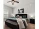 Comfortable bedroom features stylish decor, a ceiling fan, and soft, inviting bedding at 2733 Big Timber Dr, Kissimmee, FL 34758