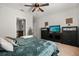 Well-lit bedroom with sleek furniture, decor, and a flatscreen television at 2733 Big Timber Dr, Kissimmee, FL 34758