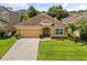 Charming single-story home with a well-manicured lawn and a paved driveway at 2733 Big Timber Dr, Kissimmee, FL 34758