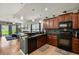 Well-lit kitchen with dark countertops, tiled floors, and stylish decor at 2733 Big Timber Dr, Kissimmee, FL 34758