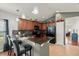 Modern kitchen with granite countertops, stainless steel appliances, and a breakfast bar at 2733 Big Timber Dr, Kissimmee, FL 34758