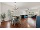 Bright living room with wood floors, a dining area, and large windows at 2733 Big Timber Dr, Kissimmee, FL 34758