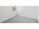 Bright bedroom with gray carpet, window, and white walls at 2770 Virginia Pine Dr, Bartow, FL 33830