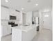 Bright kitchen features white cabinets, stainless steel appliances, and a large center island with sink at 2770 Virginia Pine Dr, Bartow, FL 33830