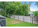 Large backyard with a tall wooden fence and a view of the screened-in pool at 283 Haverclub Ct, Longwood, FL 32779