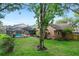 The backyard features a screened-in pool, an expansive yard, and mature trees at 283 Haverclub Ct, Longwood, FL 32779