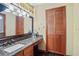 Bathroom featuring a granite vanity, modern fixtures, and wood-look floor, exuding warmth and functionality at 283 Haverclub Ct, Longwood, FL 32779