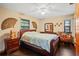Comfortable bedroom with rich wood accents, a plush bed, and bright, sunny windows at 283 Haverclub Ct, Longwood, FL 32779
