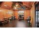 Wood-paneled bonus room with wood-look flooring, a ceiling fan, and access to the pool area at 283 Haverclub Ct, Longwood, FL 32779