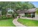 Quaint home with lush front yard and a charming pathway leading to the front door at 283 Haverclub Ct, Longwood, FL 32779
