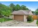 Spacious garage with a clean, well-kept driveway and landscaping at 283 Haverclub Ct, Longwood, FL 32779