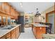 Modern kitchen with granite countertops, stainless steel appliances, and an island with seating at 283 Haverclub Ct, Longwood, FL 32779