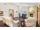Bright living room with a cozy brick fireplace, vaulted ceilings, hardwood floors and comfortable furnishings at 283 Haverclub Ct, Longwood, FL 32779