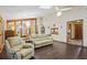 Sunlit living room with skylights, gleaming floors, and views of bonus space and entryway at 283 Haverclub Ct, Longwood, FL 32779
