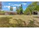 Large backyard space with a firepit and mature landscaping at 2838 Maldive Ct, Deltona, FL 32738