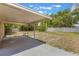 A covered patio and spacious backyard with mature trees and a white fence at 2838 Maldive Ct, Deltona, FL 32738