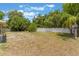 A spacious backyard with mature trees and a white fence at 2838 Maldive Ct, Deltona, FL 32738