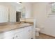 Clean bathroom featuring a granite countertop, white cabinets and toilet, and neutral tile at 2838 Maldive Ct, Deltona, FL 32738