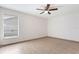 Well-lit bedroom with tiled floors, a ceiling fan, and a large window at 2838 Maldive Ct, Deltona, FL 32738