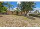 Charming home exterior with mature trees and landscaped front yard at 2838 Maldive Ct, Deltona, FL 32738