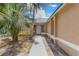 Front entrance to a tan home with a white door, leading up a sidewalk bordered with landscaping at 2838 Maldive Ct, Deltona, FL 32738