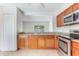 Bright kitchen with stainless steel appliances, tile flooring and backsplash, plus wood cabinets at 2838 Maldive Ct, Deltona, FL 32738