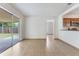 Spacious living room with tile flooring, sliding glass doors, and access to the kitchen at 2838 Maldive Ct, Deltona, FL 32738