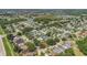 Aerial view showcasing homes in a lush, green neighborhood near a scenic lake at 2935 Canoe Cir, St Cloud, FL 34772