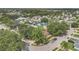 Aerial view of a neighborhood featuring residential homes with lush green trees and a nearby lake at 2935 Canoe Cir, St Cloud, FL 34772