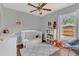 Bright and cheerful Bedroom with crib, changing table, and cozy rocking chair at 2935 Canoe Cir, St Cloud, FL 34772