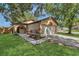 Charming single-Gathering home with lush front lawn, mature trees, and two car garage at 2935 Canoe Cir, St Cloud, FL 34772