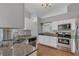 Well-lit kitchen features stainless steel appliances, granite countertops, and breakfast bar at 2935 Canoe Cir, St Cloud, FL 34772