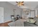 Cozy living room with ceiling fan, wainscoting details, and backyard views at 2935 Canoe Cir, St Cloud, FL 34772