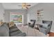 Inviting living room offering backyard access, comfortable seating, and built-in shelving at 2935 Canoe Cir, St Cloud, FL 34772