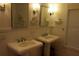 Bright bathroom featuring double sinks, mirrors, and a window for natural light at 310 W Lake Ave, Auburndale, FL 33823