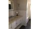Bathroom featuring a vanity with a sink and a bathtub with tiled walls at 310 W Lake Ave, Auburndale, FL 33823