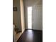 Entryway features dark wood floors, a white door, and a carpeted staircase at 310 W Lake Ave, Auburndale, FL 33823