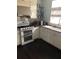 Updated kitchen features granite countertops, modern appliances, and stainless steel range hood at 310 W Lake Ave, Auburndale, FL 33823