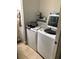 Laundry room featuring a modern washer and dryer set and ample storage space at 310 W Lake Ave, Auburndale, FL 33823