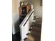 Carpeted staircase features white railing with a bookcase at 310 W Lake Ave, Auburndale, FL 33823