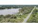 An aerial view of a private lakefront property surrounded by lush trees with pool and outbuildings at 369 Bluff Lake Rd, Mascotte, FL 34753