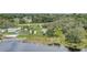 An aerial view showcases the beautiful homesite and backyard leading to the water at 369 Bluff Lake Rd, Mascotte, FL 34753