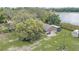 This aerial showcases the home with its spacious yard and wooded surroundings at 369 Bluff Lake Rd, Mascotte, FL 34753