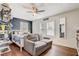 Relaxing bedroom showcases a sofa, stylish decor, hardwood flooring and a large window at 369 Bluff Lake Rd, Mascotte, FL 34753