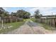 Gravel driveway leads to a charming home with views of the serene lake at 369 Bluff Lake Rd, Mascotte, FL 34753
